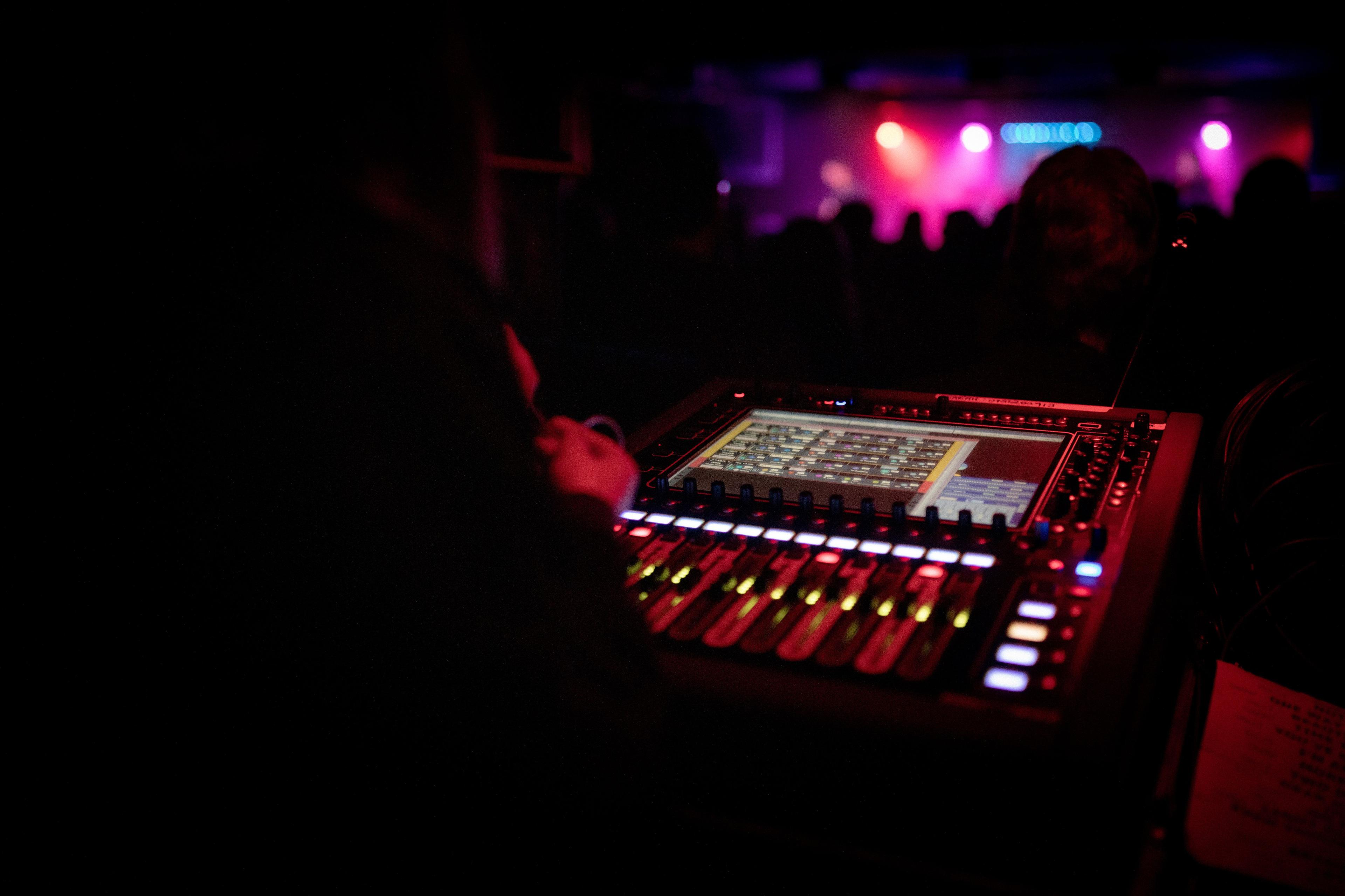 A digital audio control panel, with several lights and sliders.