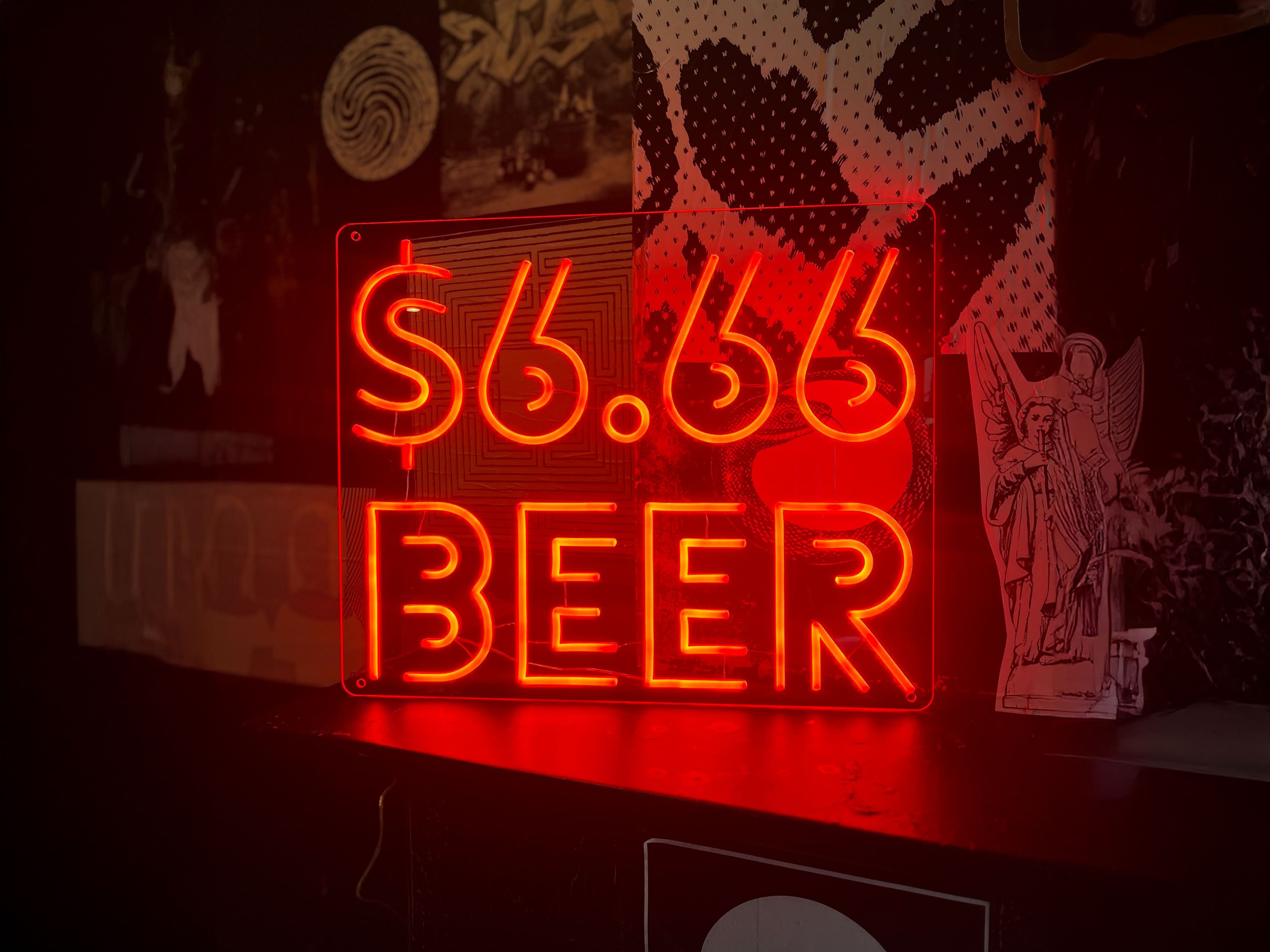 A red neon sign '6.66 beer'.